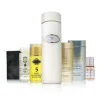 Une sélection de l'ENSEMBLE ECLAT MIRACLE (AVEC HUILE CORPORELLE BIOLOGIQUE) - des bouteilles, des pots, une savonnette noire et deux ampoules - présentée en rangées sur un fond blanc.