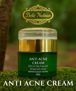 A green and gold jar of ANTI-ACNE LIGHTENING CREAM CLEANSER FOR BROWN SPOTS sits on moss, labeled as rich in tea tree oil and salicylic acid to help fade brown spots, with branding and product details visible.