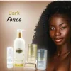 A woman with dark skin stands next to the LIGHTENING KIT FOR DARK SKIN, featuring bottles and jars, with "Dark Foncé" shown in the background.
